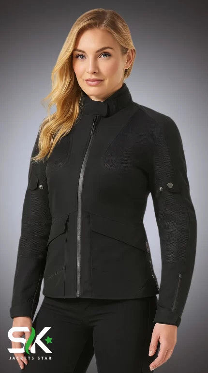 Front view of a blonde female model wearing our women's black technical softshell jacket with textured shoulder panels and snap arm adjusters.