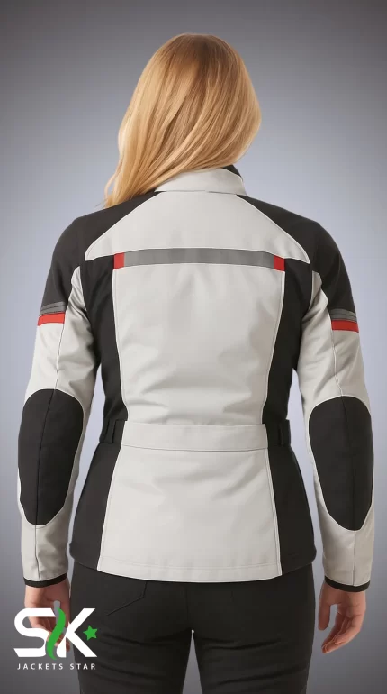 Rear view of a blonde female model wearing our manufactured light grey and black textile motorcycle riding jacket featuring high-visibility reflective striping with red accents and reinforced elbow panels.