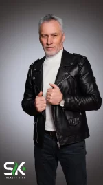 Front studio shot of our handcrafted men's black genuine leather biker jacket with shoulder epaulets, wide snap lapels, and asymmetrical zipper closure.
