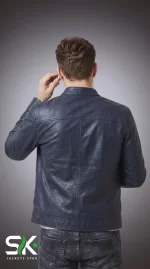 Rear studio view of our handcrafted men's navy blue genuine leather cafe racer jacket showing structured panel stitching and mandarin collar.