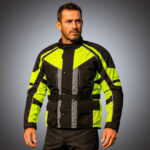 Front view of a men's heavy-duty motorcycle adventure jacket in black and charcoal with large neon yellow high-visibility panels, multiple utility pockets, and adjustable waist straps for bulk OEM production.