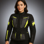 Front view of a women's black and charcoal technical motorcycle jacket with vibrant neon yellow high-visibility accents, dual chest zippers, and adjustable waist.