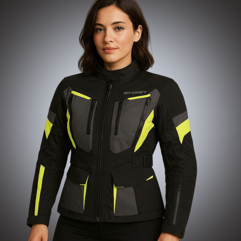 Front view of a women's black and charcoal technical motorcycle jacket with vibrant neon yellow high-visibility accents, dual chest zippers, and adjustable waist.