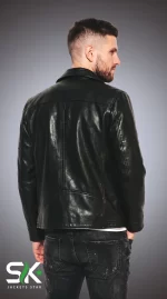 Back view studio shot of our handcrafted men's black genuine leather biker jacket showcasing structured shoulder yoke and clean vertical seams.