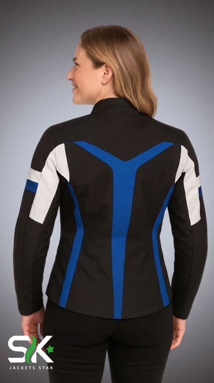 Back view of a female model wearing a fitted black textile motorcycle jacket with royal blue geometric overlays and white sleeve accents.