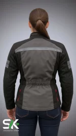 Rear perspective of a female model wearing our manufactured grey and black textile motorcycle riding jacket with high-visibility reflective striping and cinched elastic waist.