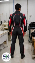 Rear view of model wearing black, red, and white high-abrasion Cordura go-kart suit inside Sialkot manufacturing factory.