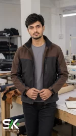 Front view of a male model wearing our custom manufactured brown and black softshell jacket inside our apparel factory.
