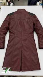 Top-down flat lay back view of our manufactured maroon longline leather coat displaying padded shoulder inserts and a central movement vent.