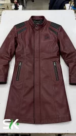 Top-down flat lay view of our custom manufactured maroon leather longline coat with padded shoulder inserts, snap-button stand collar, and long vertical side zip pockets.