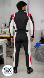 Rear view of model wearing black white and red Cordura go-kart racing suit inside Sialkot manufacturing factory.