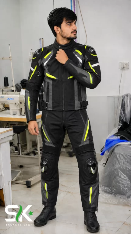 Front view of a male model demonstrating our manufactured two-piece textile riding suit featuring knee sliders and shoulder TPU protectors inside our factory studio.