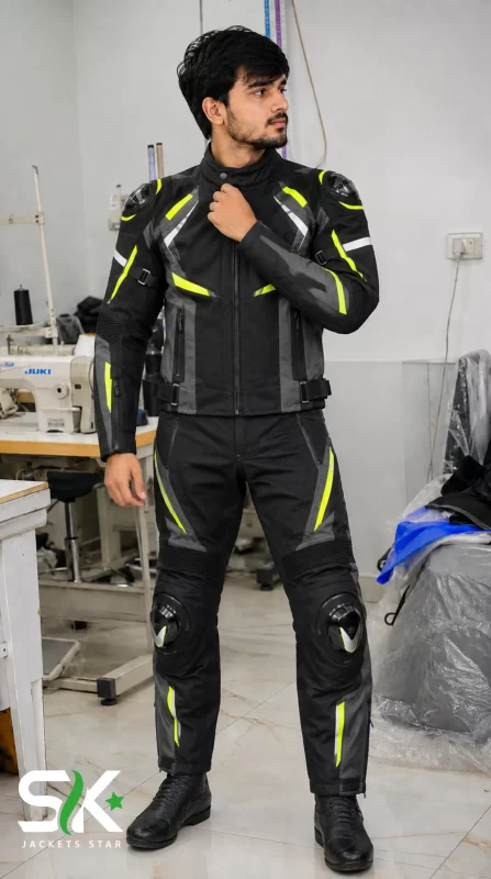 Front view of a male model demonstrating our manufactured two-piece textile riding suit featuring knee sliders and shoulder TPU protectors inside our factory studio.
