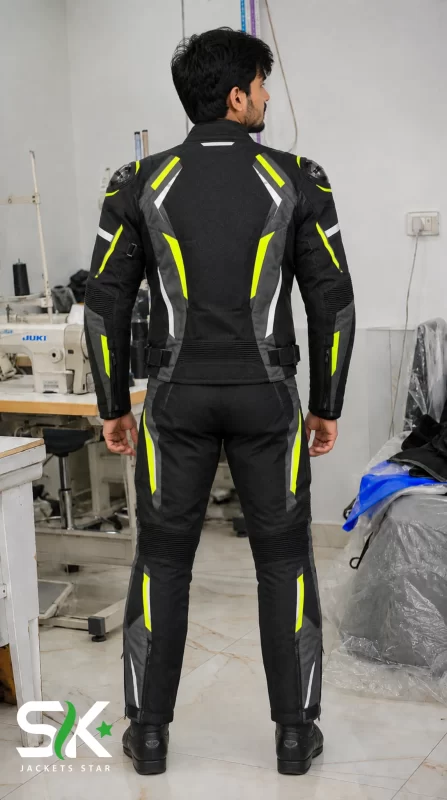 Rear perspective of a male model wearing our manufactured two-piece textile riding suit featuring fluorescent yellow panelling and stretch zones.