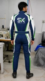 Rear view of male model wearing navy blue white and green custom go-kart racing suit with back logo in Sialkot apparel factory.