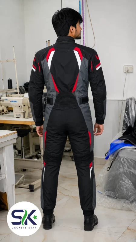 Rear view of man wearing black grey and red full-body motorcycle racing suit manufactured at Sialkot apparel factory.