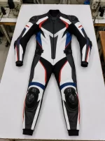 Flat lay front view of a 1-piece top grain leather motorcycle racing suit with black, white, blue, and red contrast paneling.